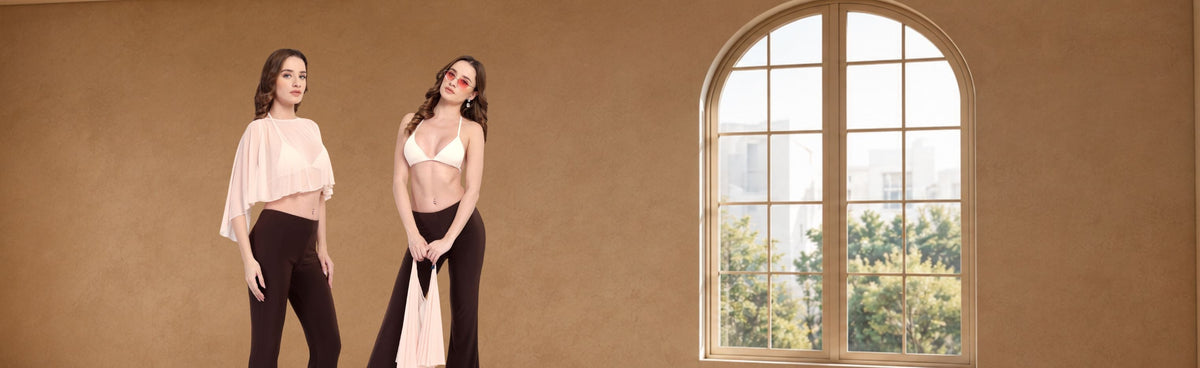A woman modeling a light cream-colored triangle halter bikini top paired with dark brown leggings, set against a plain white background.